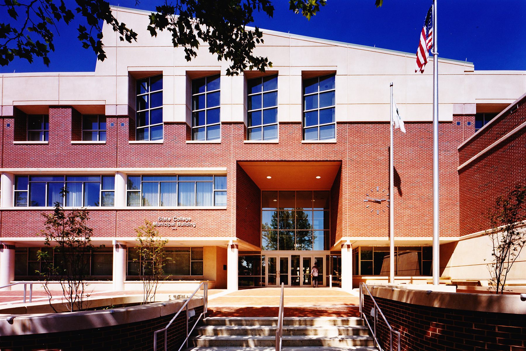 Brick civic building with symmetrical entry and flag