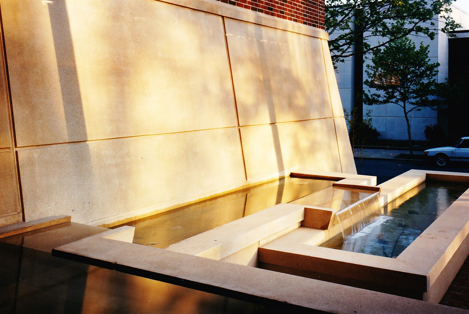 Sculptural limestone wall and water feature in daylight