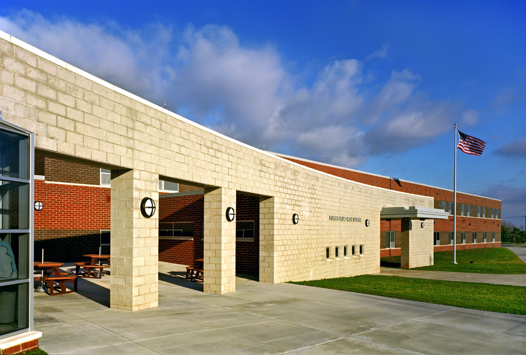 Stone middle school exterior with flag